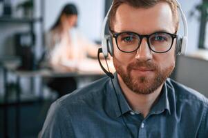 Portrait, of, man. Woman is on background. Two employees are working together in the modern office photo