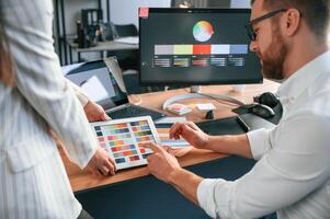 Creative job. Two designers are working, together in the modern office photo