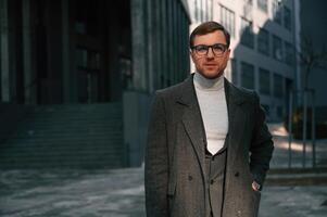 Standing near, business ,building. Handsome man in formal clothes is outdoor photo