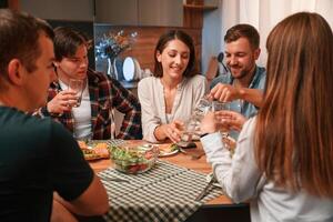 Group, of people are on the kitchen, having dinner, spending time together photo