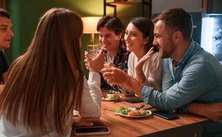 Group, of people are, on the kitchen, having dinner, spending time together photo