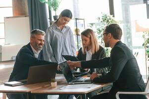 Having ,conversation, talking, about plan. Group of business people are working in the modern office photo