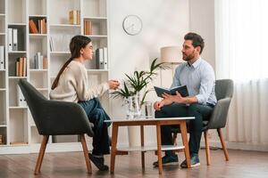 A, session, with a psychologist. With woman. Doctor in formal clothes is working in the cabinet photo
