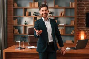 Greetings, giving the hand. Businessman in formal clothes is working indoors photo