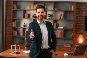 Greetings, giving the hand. .Businessman in formal clothes is working indoors photo