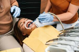 Using tools to install the aligner., Woman in the stomatology clinic, visiting dentist photo