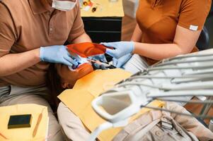 Procedure ,of, installation of aligner in progress. Woman in the stomatology clinic, visiting dentist photo