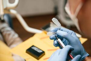 The ,aligner.. Close up view of dentist equipment. Doctor with gloves photo