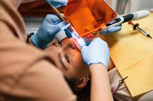 Procedure of ,installation of aligner in progress. Woman in the stomatology clinic, visiting dentist photo