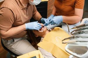 Procedure of, installation of aligner in progress. Woman in the stomatology clinic, visiting dentist photo