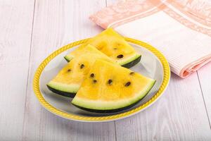 A plate of sliced watermelon on a table photo