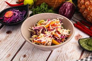 A bowl of salad with various vegetables and other ingredients photo