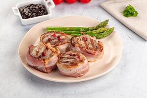 A plate of food with asparagus and bacon photo