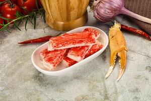Raw crab meat in a bowl with a knife and garlic photo