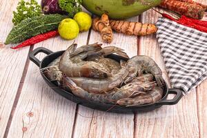A pan of shrimp on a wooden table photo