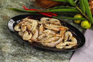 A plate of cooked shrimp on a table photo