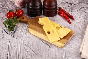 Cheese and other ingredients on a cutting board photo