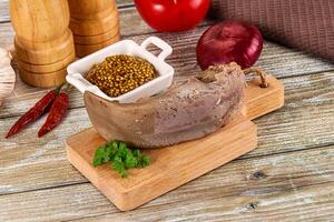 A meat and vegetables on a cutting board photo