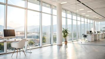 Modern, spacious office with large windows, natural light, and a scenic mountain view, featuring sleek desks, chairs, and minimalistic design. photo