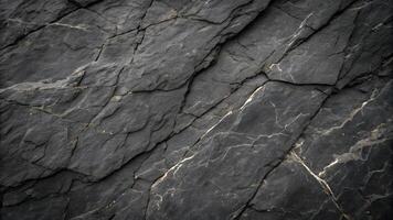 Dark slate rock surface with natural cracks and textures, perfect for backgrounds or design elements requiring a rugged, natural look. photo