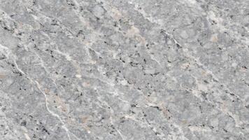 Gray marble surface with white and black veining, perfect for background or texture in design projects. photo