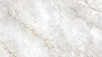 Elegant white marble surface with intricate gray and gold veining, perfect for backgrounds or design elements requiring a luxurious touch. photo