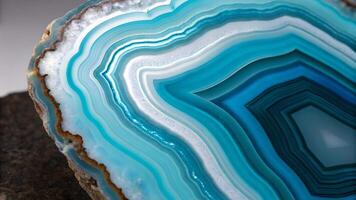 A stunning close up of a blue agate slice with mesmerizing concentric bands ranging from light to deep blue, showcasing the natural beauty and intricate patterns of the mineral. photo
