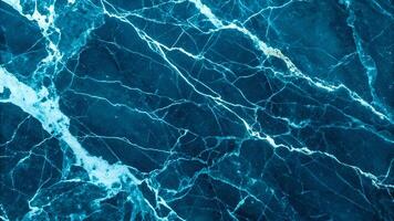 Dark blue marble texture with intricate white veining, perfect for backgrounds and design elements requiring a touch of natural elegance and sophistication. photo