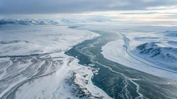 Aerial View of Snowy Landscape with Frozen River and Mountain Range for Nature Enthusiasts snow photo
