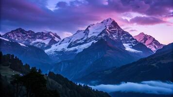 Snowy mountain peaks glowing at sunset in a serene valley for nature enthusiasts and photographers landscape photo
