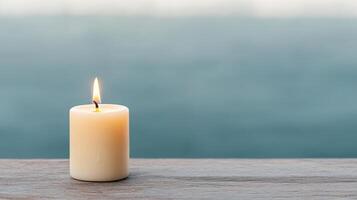 glowing candle stands resiliently on wooden surface, radiating warmth photo
