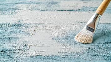 brush applying texture on painted surface, creating artistic effect photo