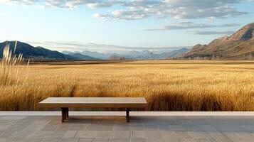 serene countryside view featuring wooden bench overlooking golden fields and mountains photo