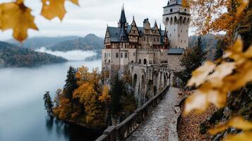 majestic old castle standing atop hill surrounded by autumn foliage photo