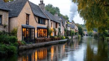 Picturesque riverbank with rustic houses and smoke rising from chimneys photo