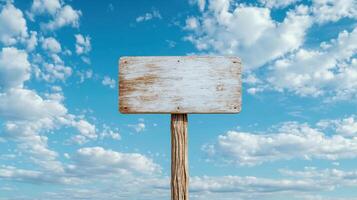 blank wooden sign against blue sky with fluffy clouds evokes sense of openness and possibility photo