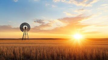 windmill stands in golden field at sunset, creating serene landscape photo