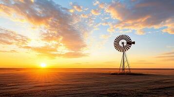 farm windmill stands against stunning sunset backdrop, creating serene atmosphere photo