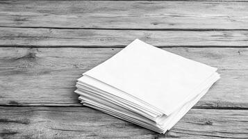 Blank sheets of paper stacked on rustic wooden table, ready for use photo