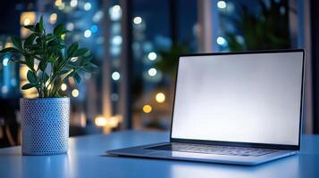 modern laptop on desk with plant, creating serene workspace ambiance photo