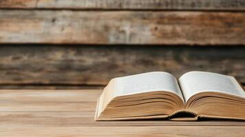 open book resting on wooden table, revealing its pages photo