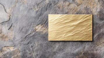 Luxurious gold foiled minimalist business card on textured stone background photo