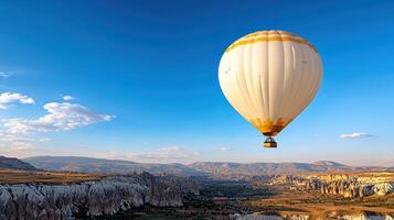 hot air balloon floats above stunning rock formations and valleys photo