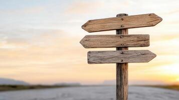 Rustic wooden road sign at crossroads with sunset backdrop photo