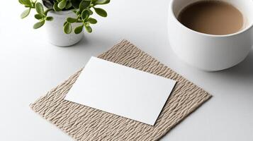 Minimalist business card on textured mat with coffee cup and plant photo