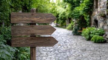 Weathered signpost in European village, guiding visitors along cobblestone path photo