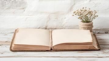 open vintage journal rests on rustic table beside small flower vase photo