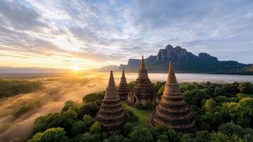 Ancient temple surrounded by lush greenery at sunrise, creating serene atmosphere photo