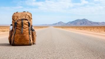 rugged backpack on dusty road, surrounded by vast desert landscape photo