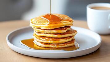 Fluffy pancakes stacked high with syrup drizzling down, perfect for breakfast photo